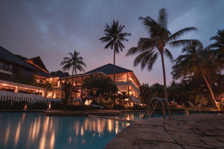 Tropical luxury resort swimming pool dusk